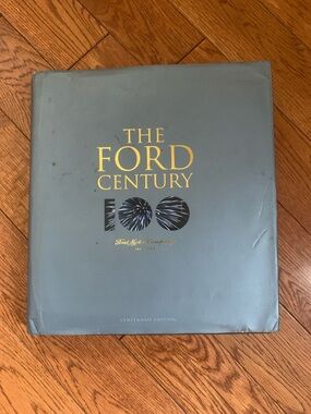 Ford hardcover book with gray cover and gold foil lettering huge coffee
